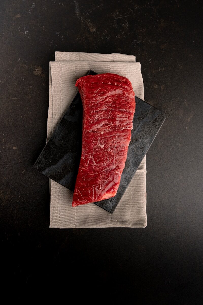 A piece of meat sitting on top of a napkin